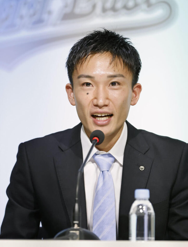 Japan's Kento Momota fields questions at a recent news conference. Momota to call it quits for good in February, according to sources